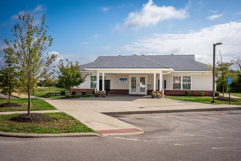 a white house with a driveway in front of it